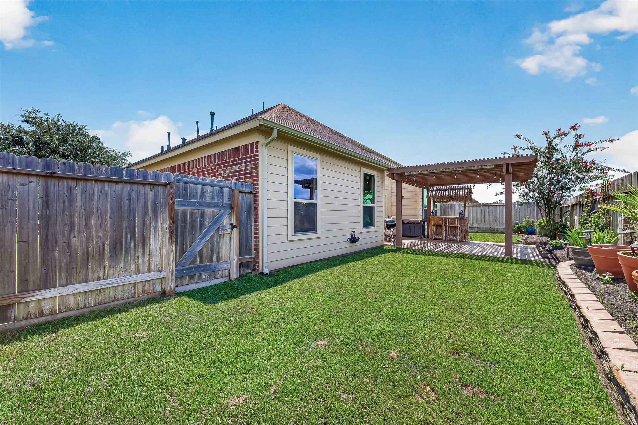 4910 Culver Lane Rosenberg, TX 77471 - Photo 43 of 50 Charming backyard with a well-maintained lawn, CEDAR wooden fencing (2025) WITH SECRET EXIT DOOR THAT LEADS TO THE GREENBELT. NO BACK NEIGHBORS!