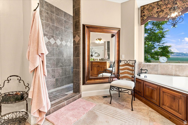 11290 South Southfield Road Mayfield, UT 84643 - Photo 68 of 103 Walk-in shower with tiled surround, soaking tub with wood-paneled base, and a large window