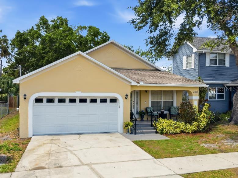 3005 West Chestnut Street Tampa, FL 33607 - Photo 3 of 27 a view of house with garden and tall tress