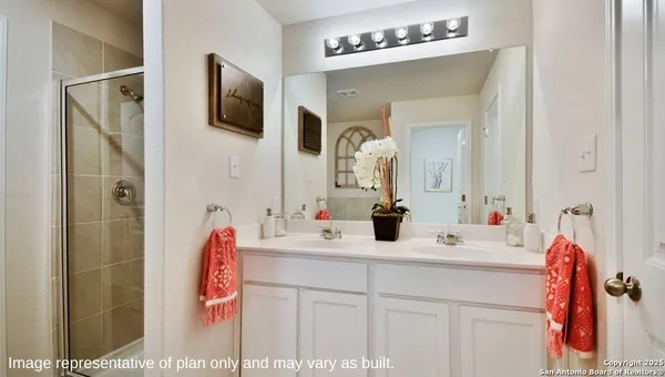 a bathroom with a sink vanity and a mirror