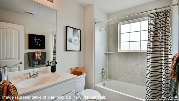 a bedroom with a bed and a dresser with mirror
