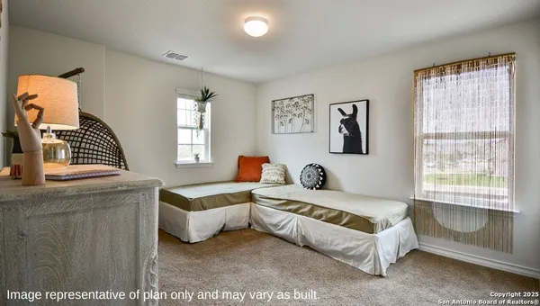 a living room with furniture a rug and wooden floor