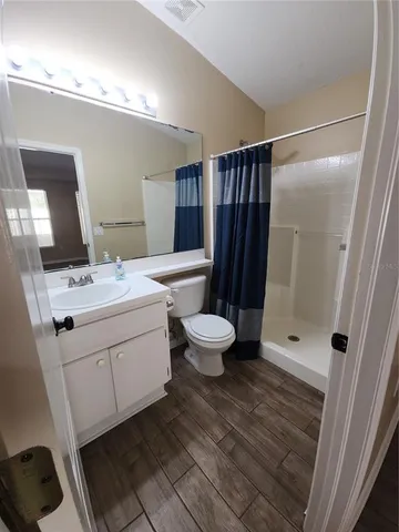 a white toilet sitting next to a bathroom sink