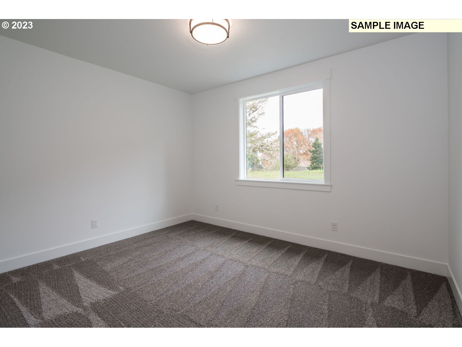 1208 South 48th Place Ridgefield, WA 98642 - Photo 18 of 21 a view of an empty room with wooden floor and a window