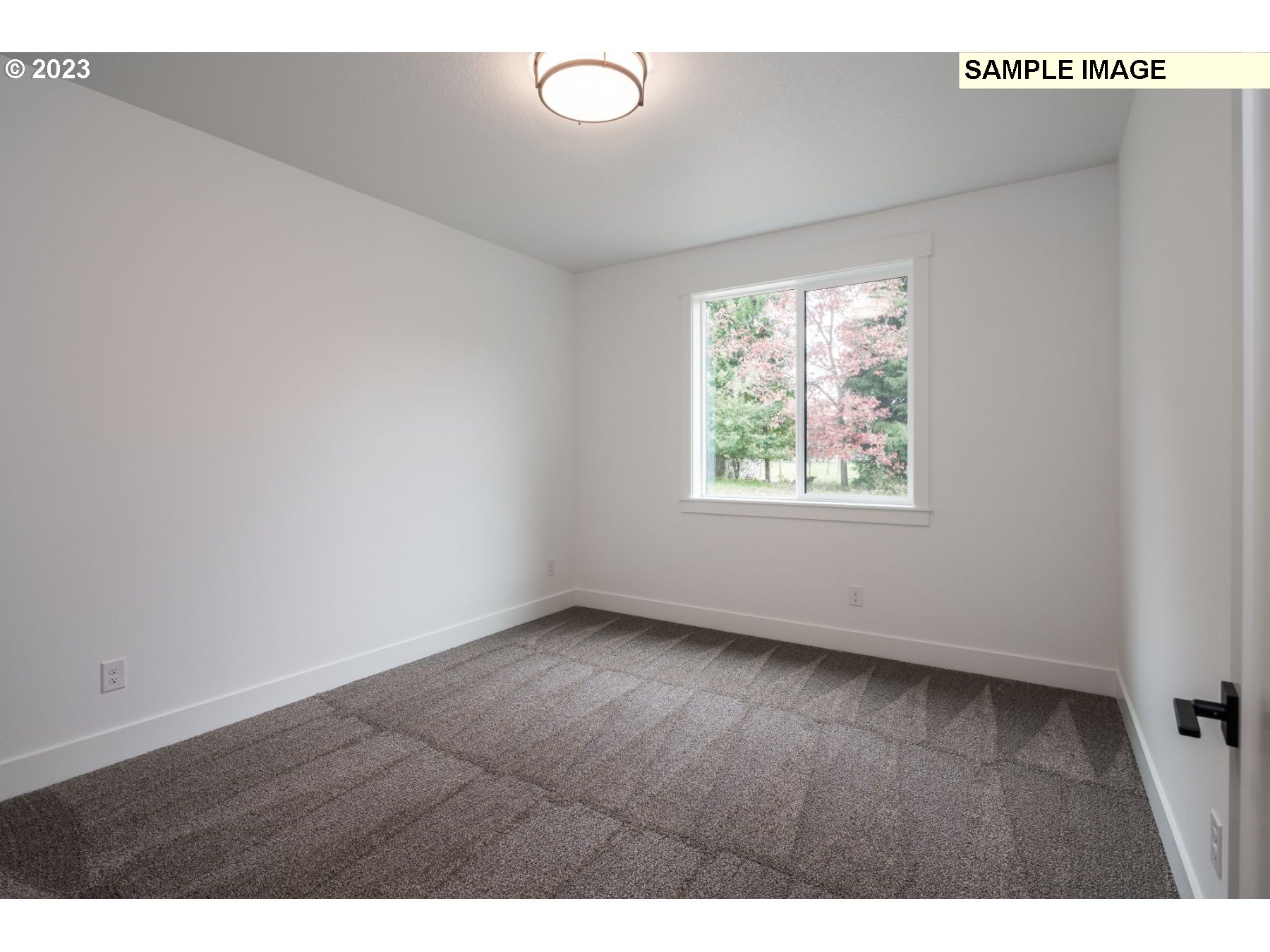 1208 South 48th Place Ridgefield, WA 98642 - Photo 19 of 21 a view of an empty room with wooden floor and a window