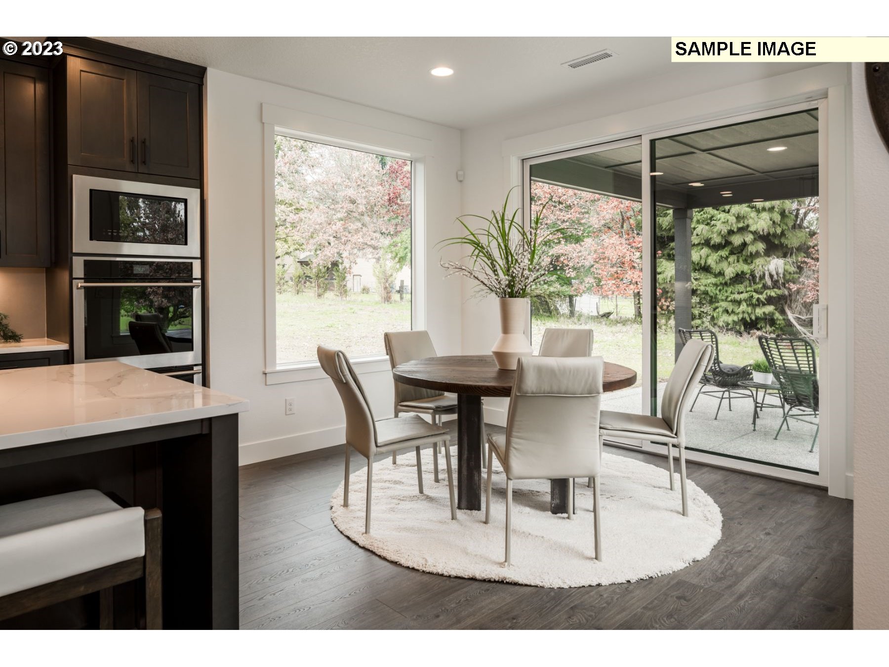 1208 South 48th Place Ridgefield, WA 98642 - Photo 9 of 21 a dining room with wooden floor a glass table and chairs