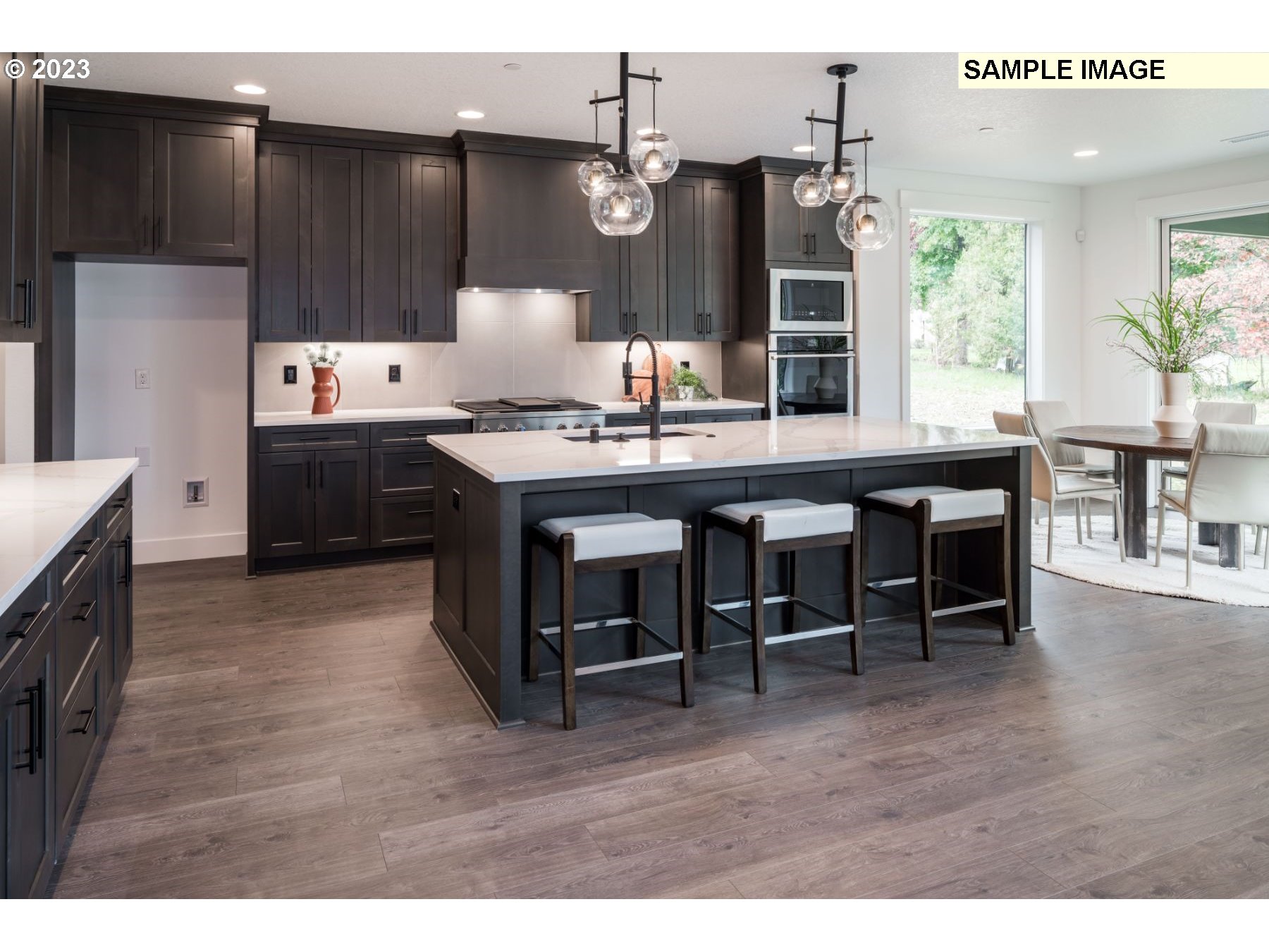 1208 South 48th Place Ridgefield, WA 98642 - Photo 10 of 21 a kitchen with a sink refrigerator and dining table