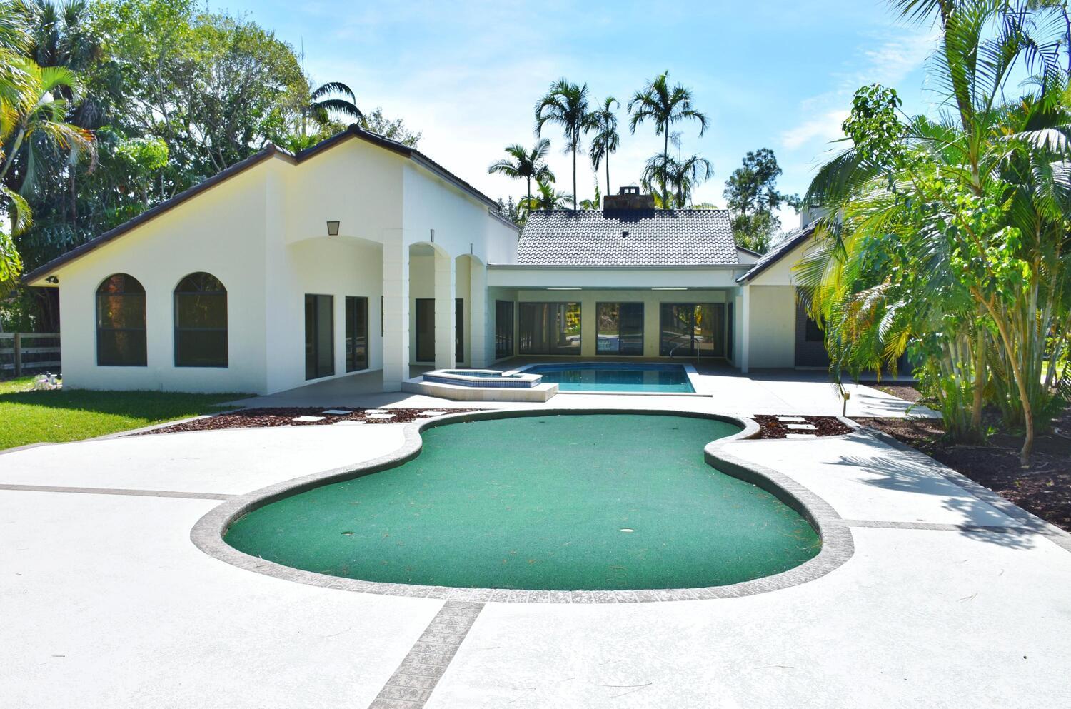 12677 Pineacre Lane Wellington, FL 33414 - Photo 19 of 38 a view of a house with a yard and sitting area