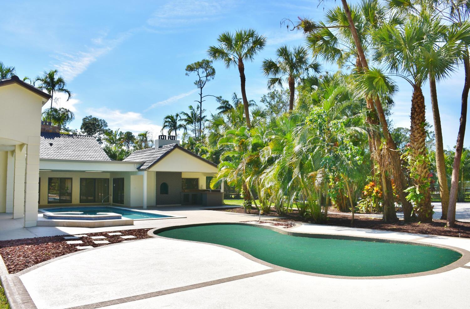 12677 Pineacre Lane Wellington, FL 33414 - Photo 20 of 38 a view of outdoor space yard and swimming pool