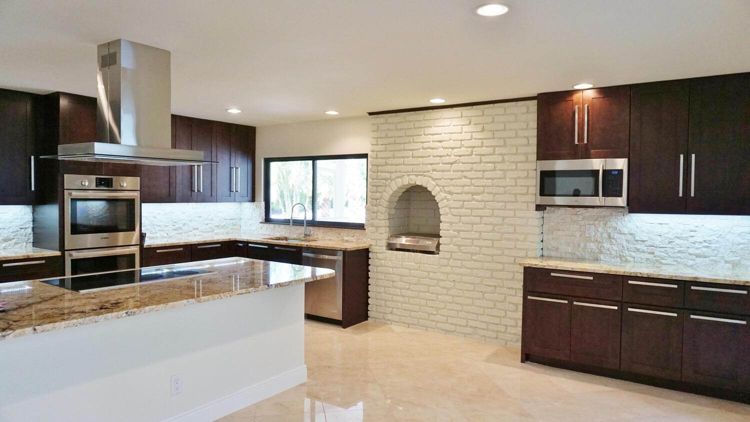 12677 Pineacre Lane Wellington, FL 33414 - Photo 2 of 38 a large kitchen with granite countertop a sink and a stove top oven