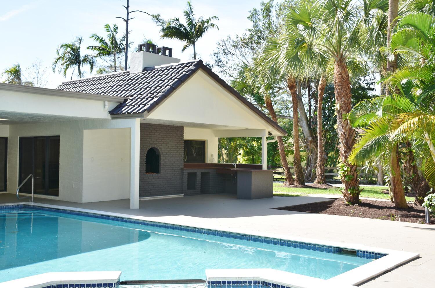 12677 Pineacre Lane Wellington, FL 33414 - Photo 21 of 38 a view of a house with a patio