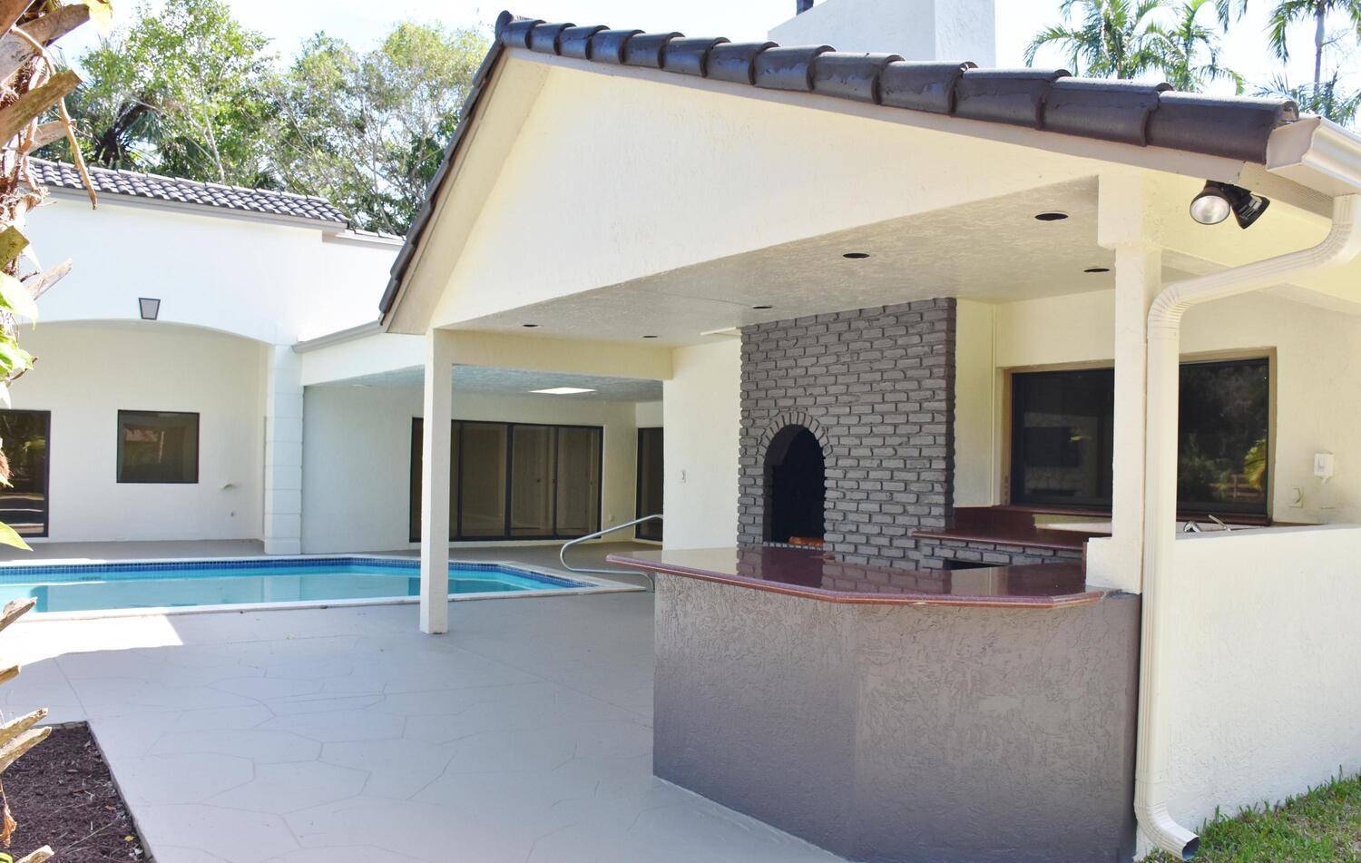 12677 Pineacre Lane Wellington, FL 33414 - Photo 25 of 38 a view of a patio with table and chairs