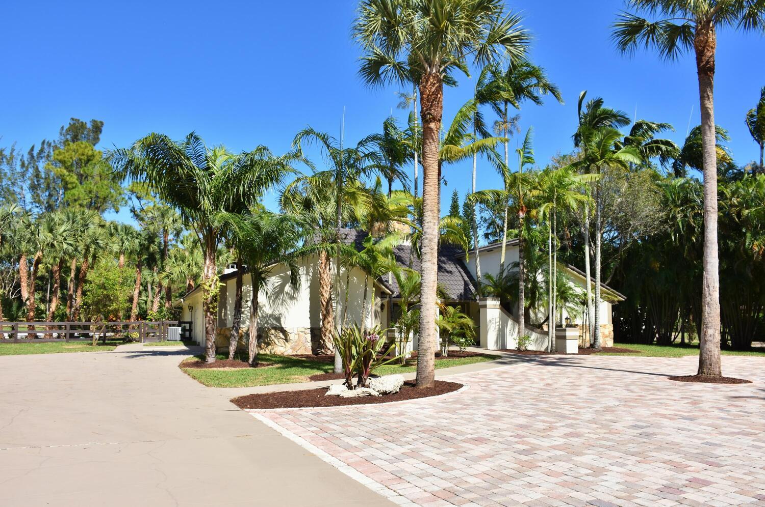 12677 Pineacre Lane Wellington, FL 33414 - Photo 26 of 38 a view of road with palm trees