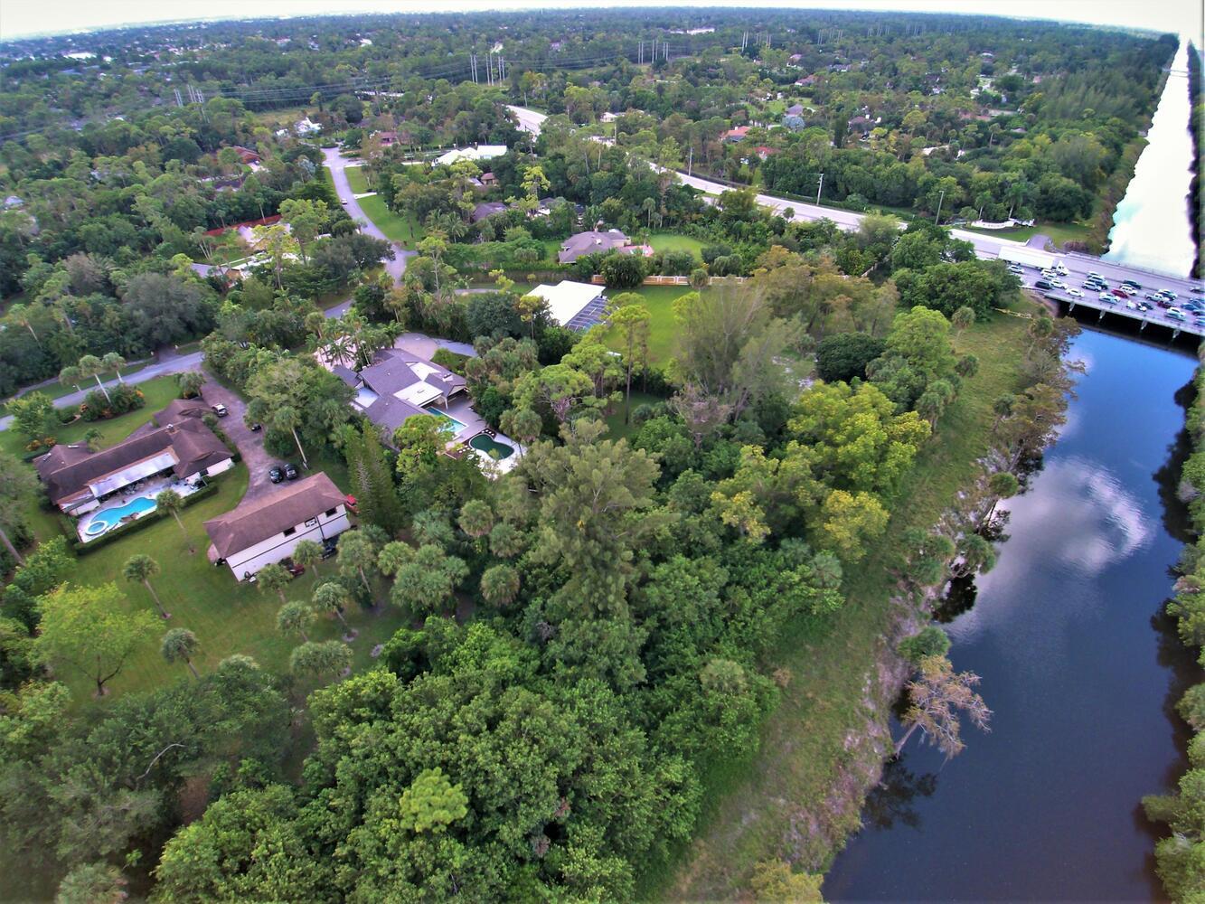12677 Pineacre Lane Wellington, FL 33414 - Photo 28 of 38 an aerial view of a house with a yard lake and mountain view in back