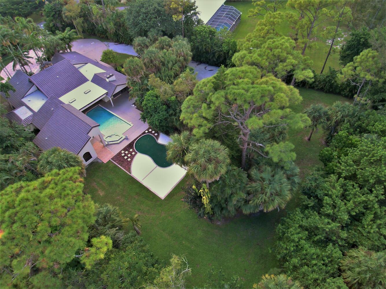 12677 Pineacre Lane Wellington, FL 33414 - Photo 29 of 38 an aerial view of residential house with outdoor space and trees all around