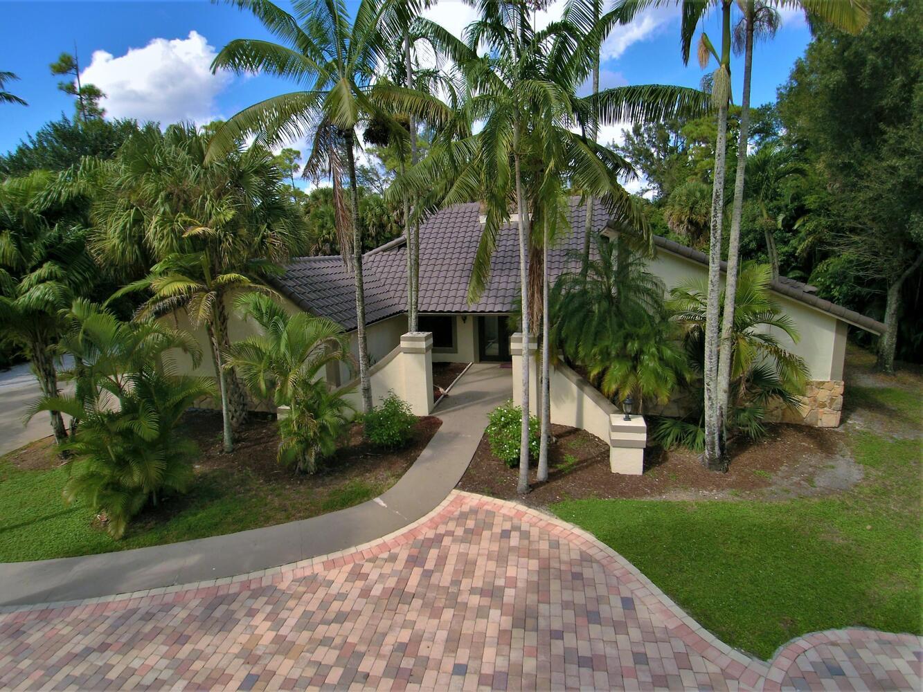12677 Pineacre Lane Wellington, FL 33414 - Photo 34 of 38 a view of a house with a yard and tree s