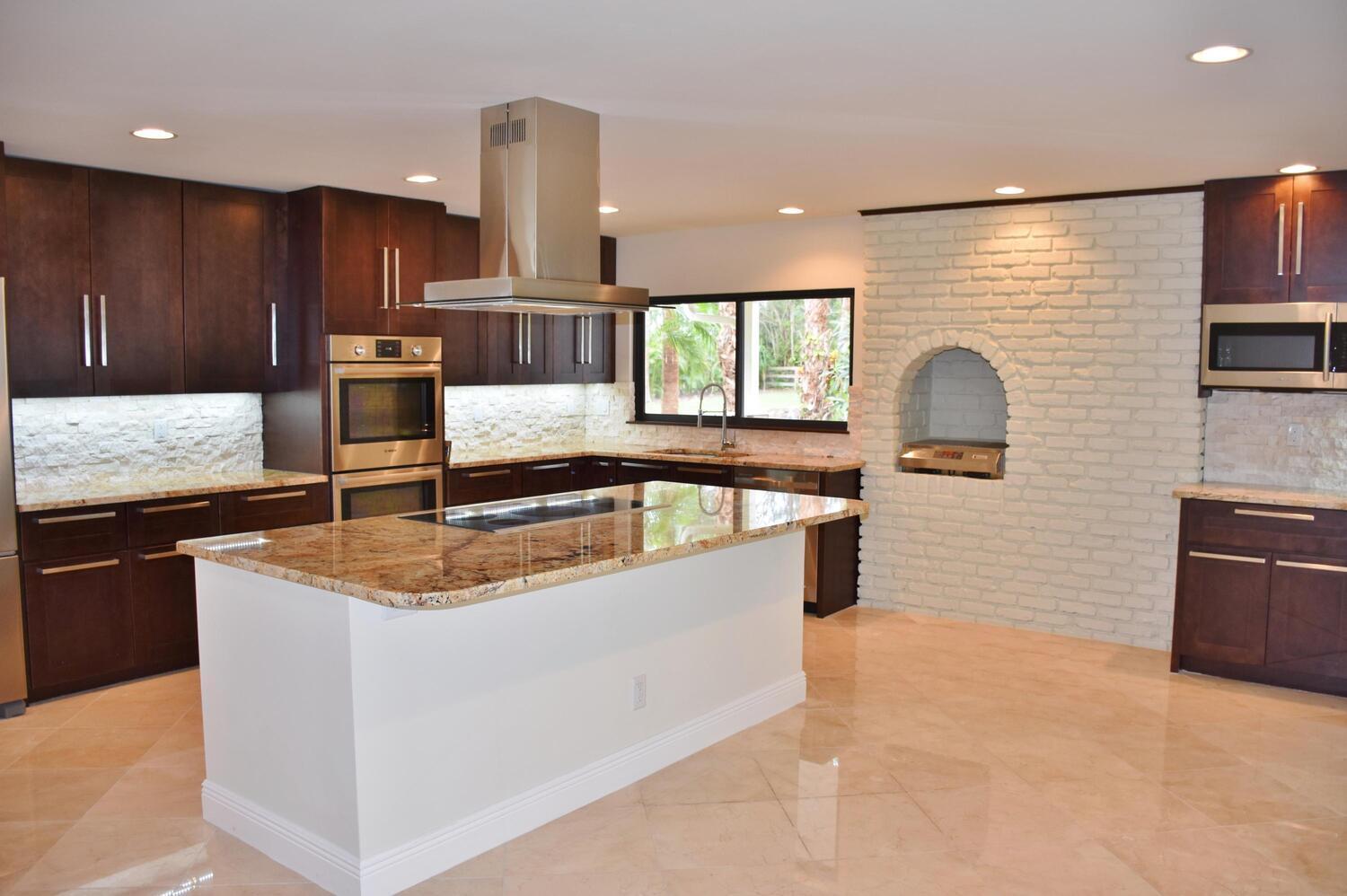 12677 Pineacre Lane Wellington, FL 33414 - Photo 5 of 38 a kitchen with stainless steel appliances granite countertop a sink and a stove