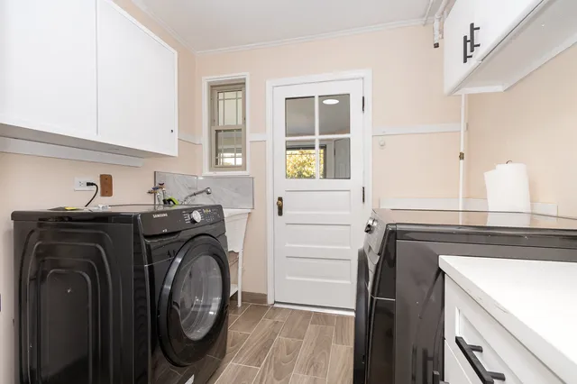 a utility room with sink dryer and washer