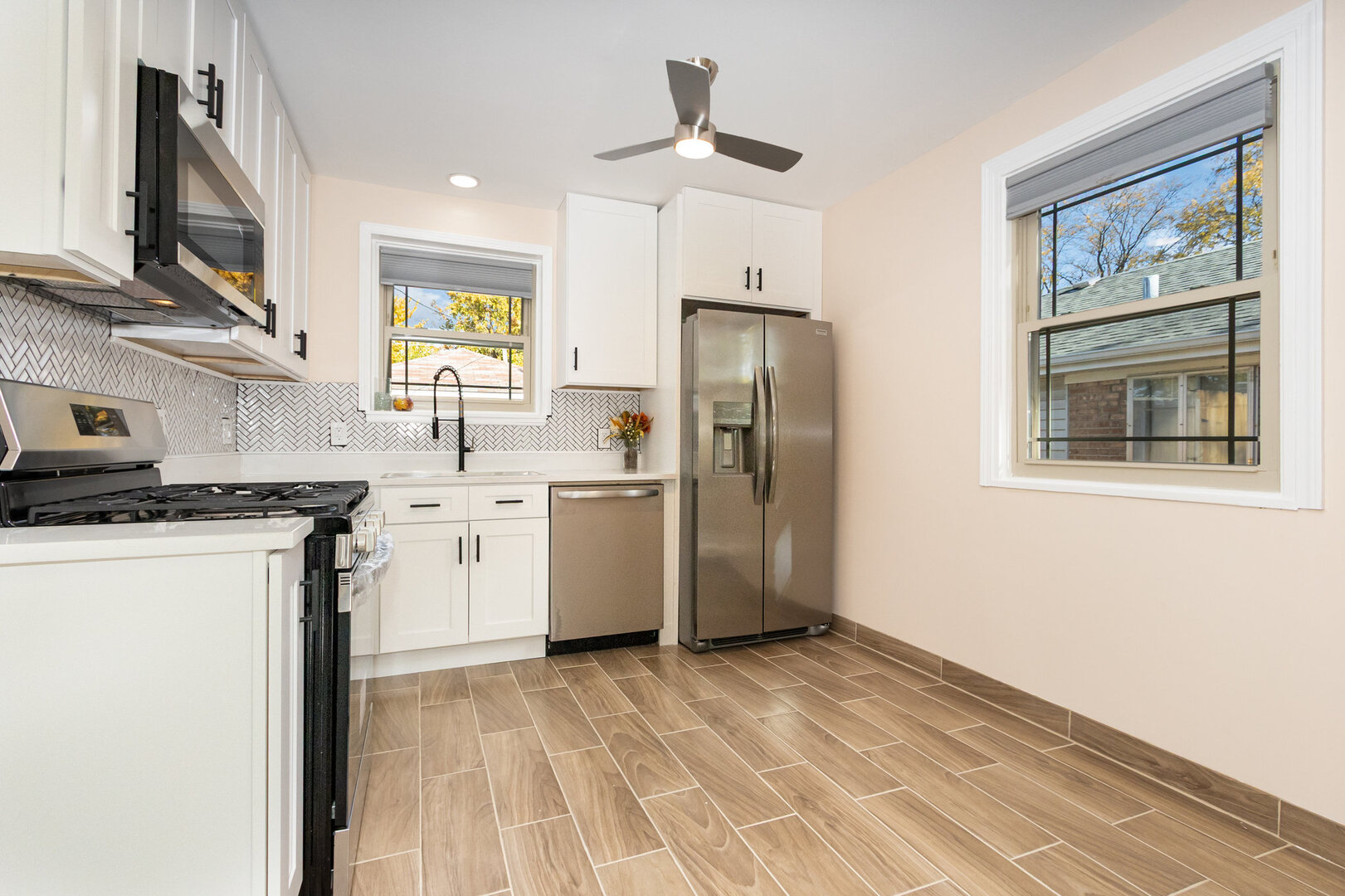 2514 Spruce Road Homewood, IL 60430 - Photo 6 of 18 a kitchen with a refrigerator a sink dishwasher and a stove with wooden floor
