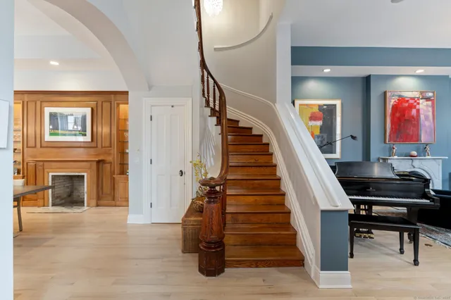 a view of entryway and hall with wooden floor