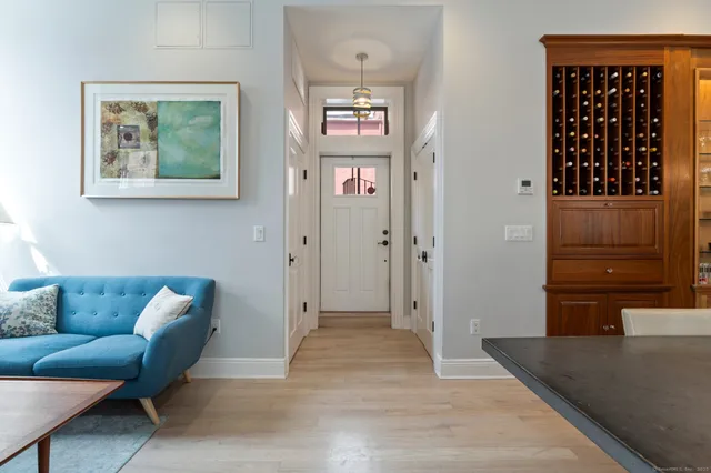 a living room with furniture and a walk in closet