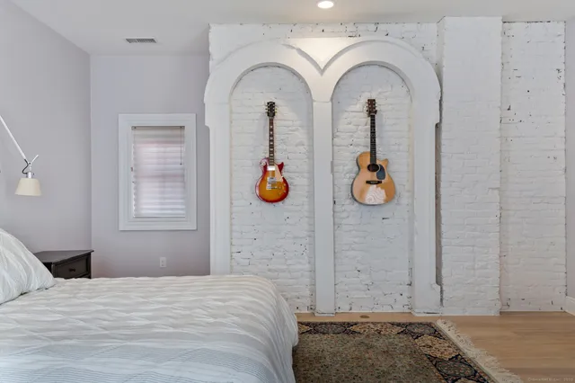 a bedroom with bed and window