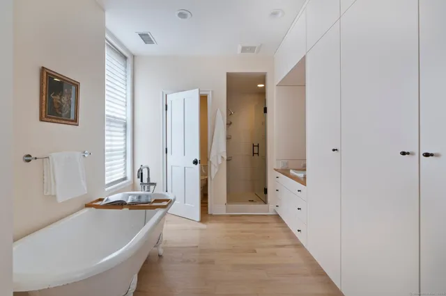 a bathroom with a tub sink and mirror