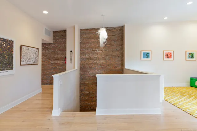 a view of a kitchen with furniture and wooden floor