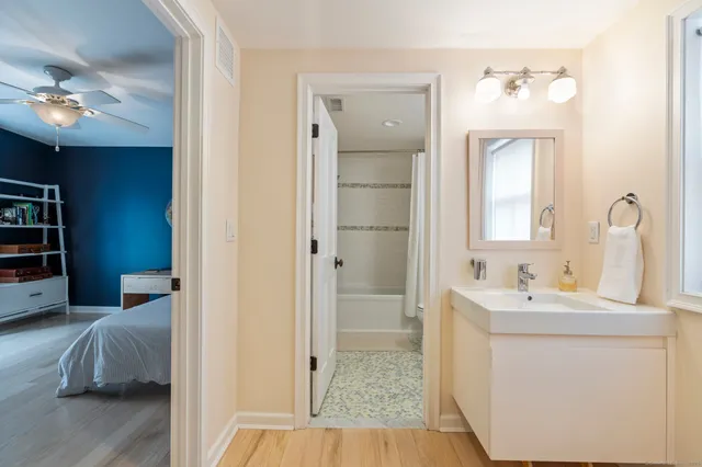a en suite bathroom with a sink a large mirror and vanity