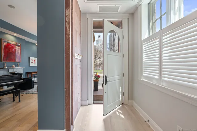 a view of a livingroom with wooden floor and a flat screen tv