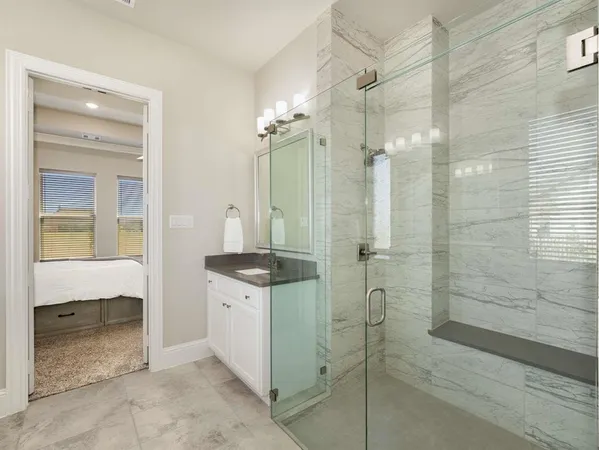 a bathroom with a shower and a sink