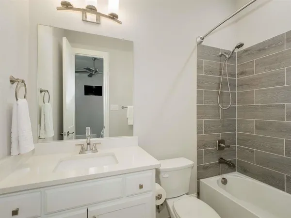 a bathroom with a sink toilet vanity and shower
