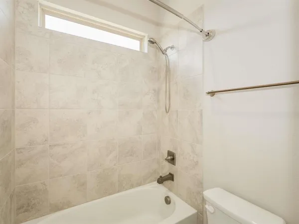 a bathroom with a shower and a toilet