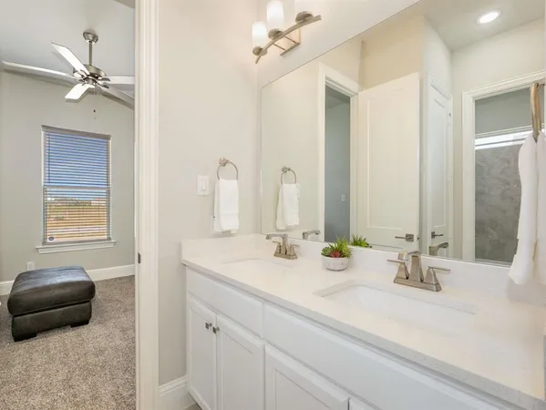 a bathroom with a double vanity sink and a mirror