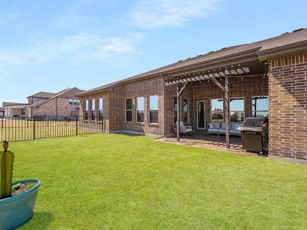 a view of a house with backyard porch and sitting area