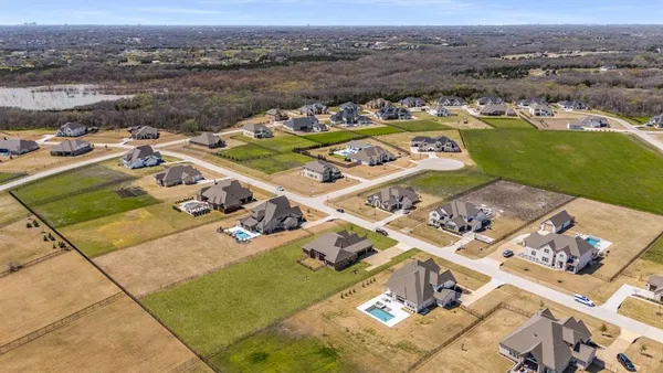 an aerial view of a house with a lake view
