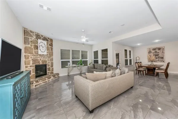 a living room with furniture a fireplace and a flat screen tv