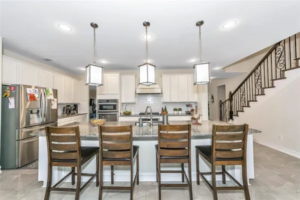 a view of kitchen with dining table chairs and wooden floor
