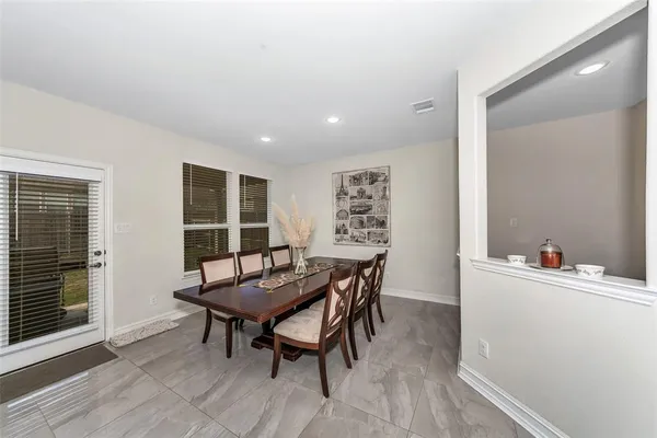 a dining room with furniture and window