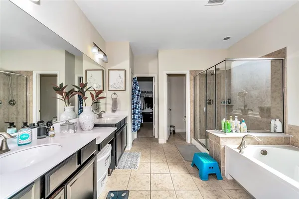a bathroom with a tub sink and mirror