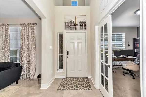 a view of a bedroom with furniture and window