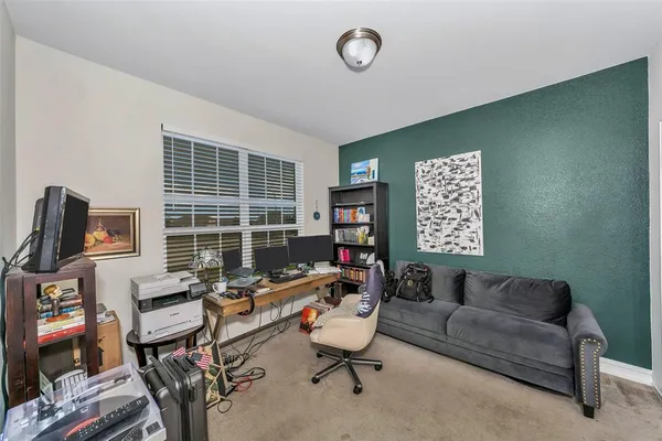 a living room with furniture a flat screen tv and a window