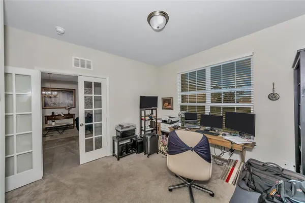 a view of a workspace with furniture and a window