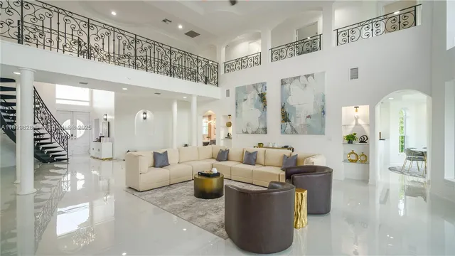 a dining room with furniture a chandelier and wooden floor
