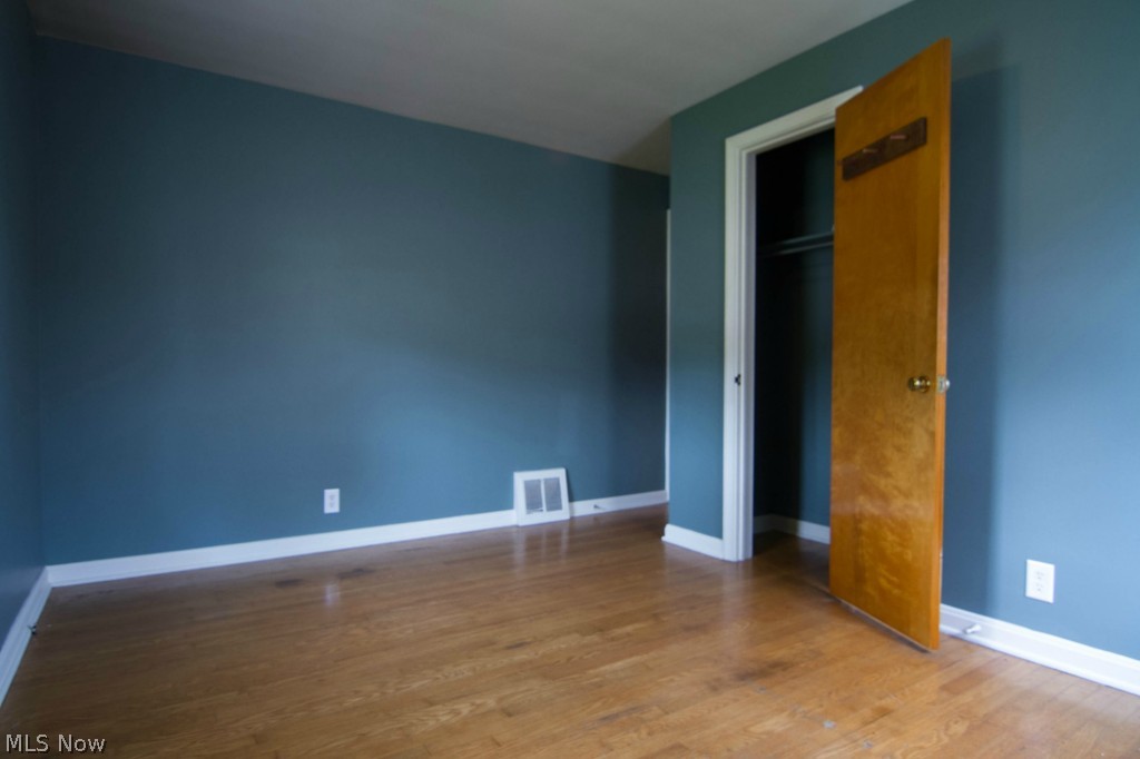3415 Birchdale Road Northwest Canton, OH 44708 - Photo 13 of 18 First floor bedroom. New vinyl windows offer lots of natural light. New interior paint. Beautiful hardwood floors.