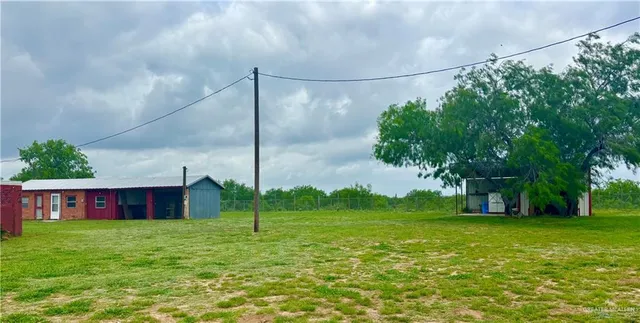 a view of a house with a backyard