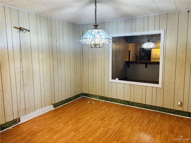 a view of a room with wooden floor and windows