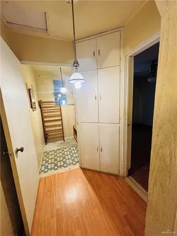 a view of an entryway with wooden floor