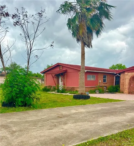 a large tree in front of a house