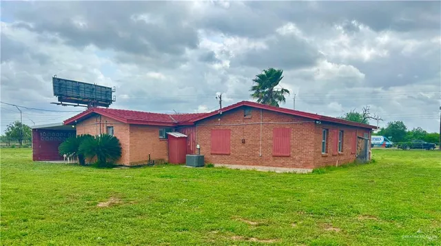 a view of a house with a yard and a garden